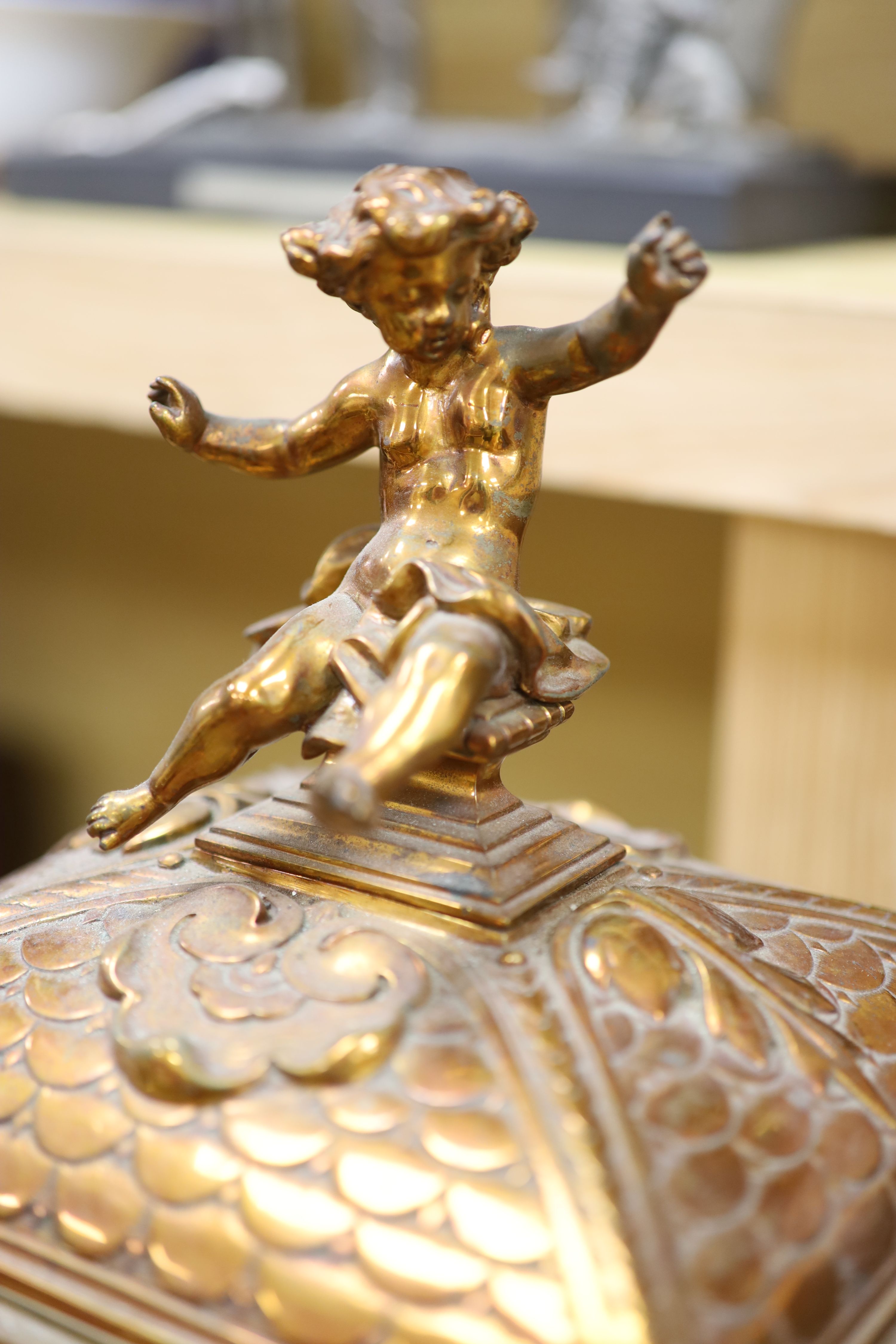 A late 19th century French cast brass cased eight day mantel clock and a carved oak clock bracket, height 50cm